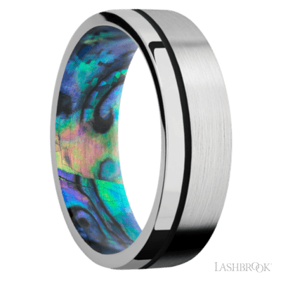 7 mm wide/Flat/14K White Gold band with one 0.5 mm Off Center inlay of Black also featuring a Abalone sleeve.